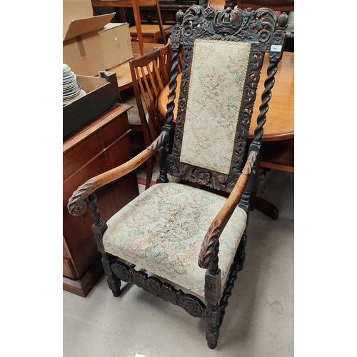 962 - A Carolean style oak armchair with crest rail having carving crown, barley twist supports with a rec... 