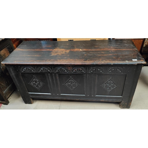 963 - An 18th/19th century oak coffer with carved panel decoration to the front, hinged lid, length 148 x ... 