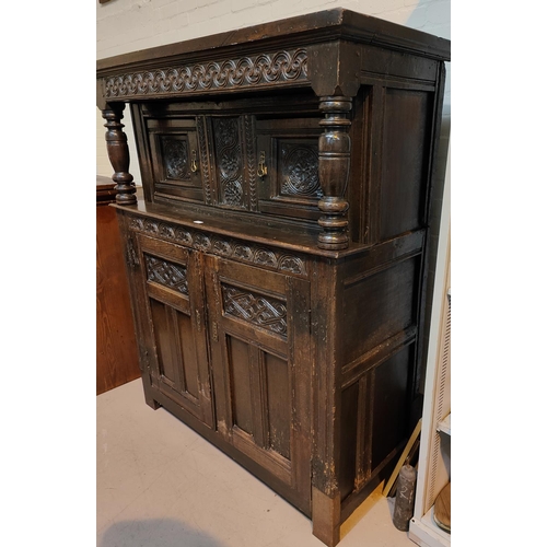 969 - An 18th century oak carved diodarn cupboard with double cupboard above and below, double support col... 