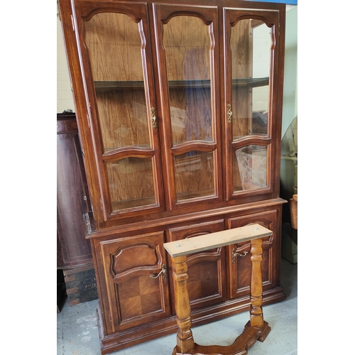 971 - A wooden dining table and four chairs with high backs and a bookcase/side cabinet, glazed above, cup... 