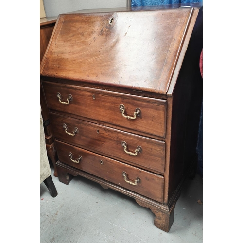 975 - A mahogany full front bureau, brass drop handles, three drawers bellow, fitted interior.