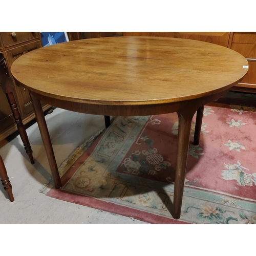 990 - A mid 20th century McIntosh circular teak extending dining table with fold out leaf, 4 tapering circ... 