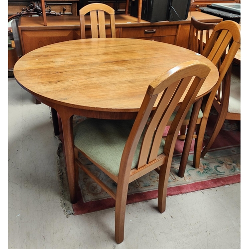 990 - A mid 20th century McIntosh circular teak extending dining table with fold out leaf, 4 tapering circ... 