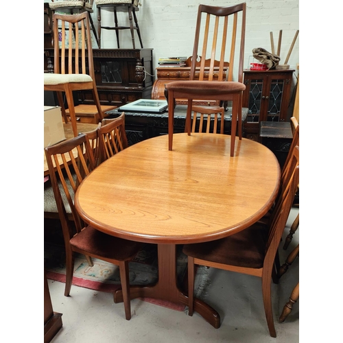 990A - A Mid 20th century G-plan teak dining suite with oval extending dining table and six high rail back ... 