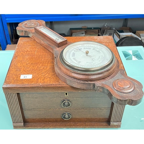 81 - An oak canteen box including various cutlery and an oak banjo aneroid barometer