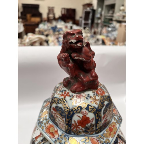 439 - A 19th century Japanese Imari octagonal lidded vase with floral decoration, Dog of Fo to finial (res... 