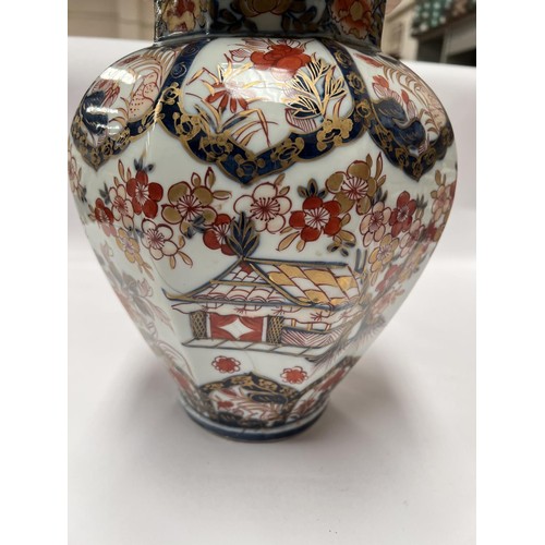 439 - A 19th century Japanese Imari octagonal lidded vase with floral decoration, Dog of Fo to finial (res... 