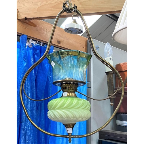 119 - A 19th century brass framed hanging oil lamp with green glass reservoir and shade