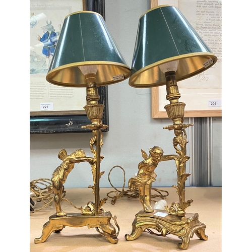 122 - A pair of ormolu table lamps with cherubs etc