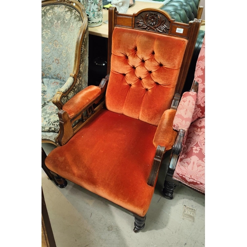 1003 - An Edwardian carved mahogany armchair in rust fabric