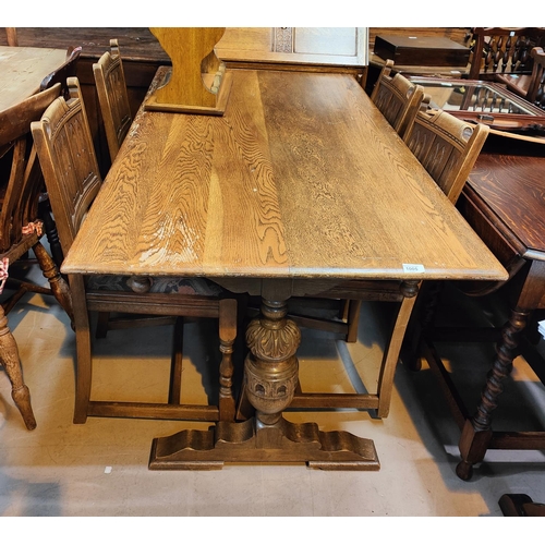 1005 - An old charm oak refectory dining table and chairs with carved columns etc.