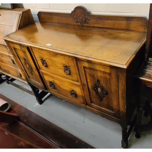 1006 - A 1930's oak barley twist sideboard, drawers and cupboards below.