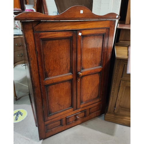 983 - A mahogany wall hanging corner cupboard, with bow front and burr walnut panels; a wall hanging corne... 