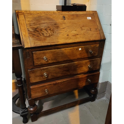 984 - An oak reproduction bureau with fall front and 3 drawers