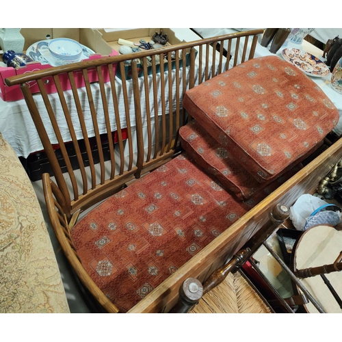 993 - A modern Ercol light wood settee lathe back and matching foot stool, approx. 195 x 96cm