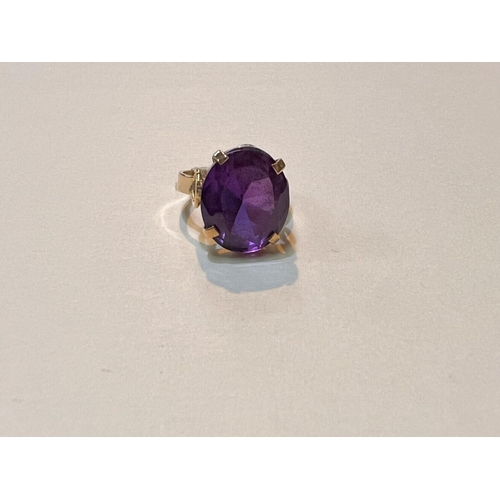 644 - A yellow metal ring with large amethyst stone, Egyptian marked, weight 5.9gms, size M.