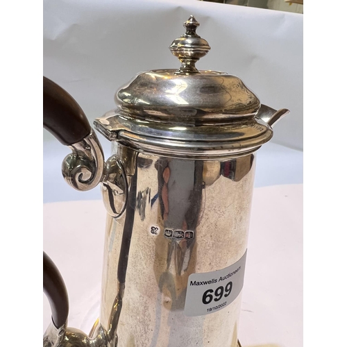 699 - A hallmarked silver hot water jug with hinged lid, shaped handle on stepped foot, Sheffield , 13.3oz