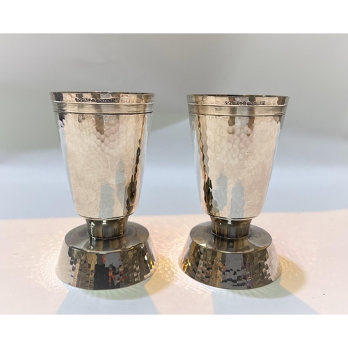 700 - A pair of silver modernist designer cylindrical planish candlesticks with flared rims and bases, ht.... 