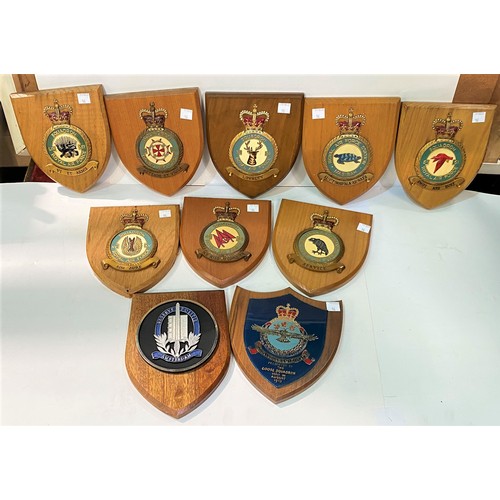 96 - Ten RAF wooden shields of various units and a selection of military pictures and prints