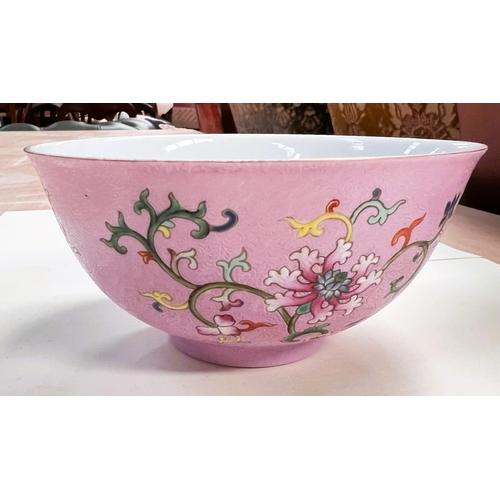 468A - A Chinese famille rose bowl with swirling incised decoration with polychrome flowers and seal mark t... 