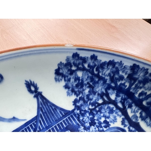 469 - A large Chinese blue & white charger with decoration of domestic mountain scene, characters to t... 