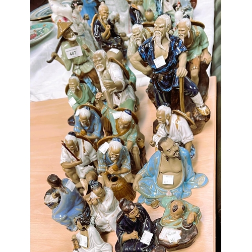 487 - A large collection of Chinese bisque and glazed figures of fishermen etc