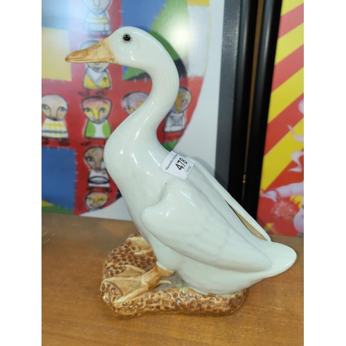 478 - A 20th century duck with white glazed decoration, ht. 22cm