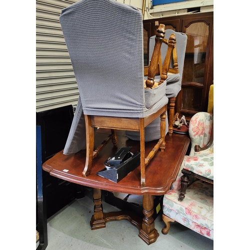 971 - A wooden dining table and four chairs with high backs and a bookcase/side cabinet, glazed above, cup... 