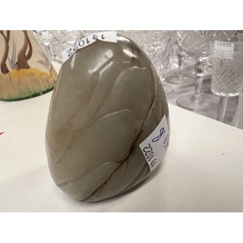 459B - A Chinese Jade coloured hard stone, carved egg shaped piece with carved decoration with cave like fo... 