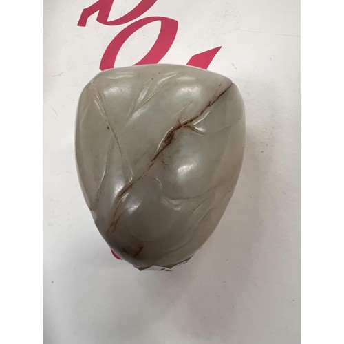 459B - A Chinese Jade coloured hard stone, carved egg shaped piece with carved decoration with cave like fo... 