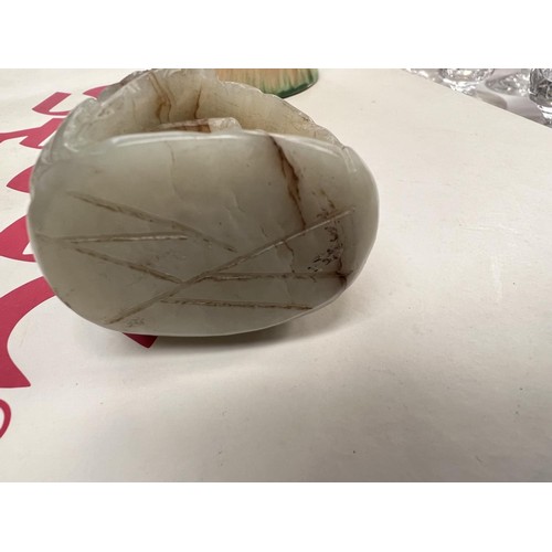 459B - A Chinese Jade coloured hard stone, carved egg shaped piece with carved decoration with cave like fo... 