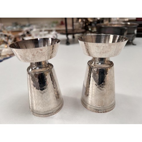 700 - A pair of silver modernist designer cylindrical planish candlesticks with flared rims and bases, ht.... 