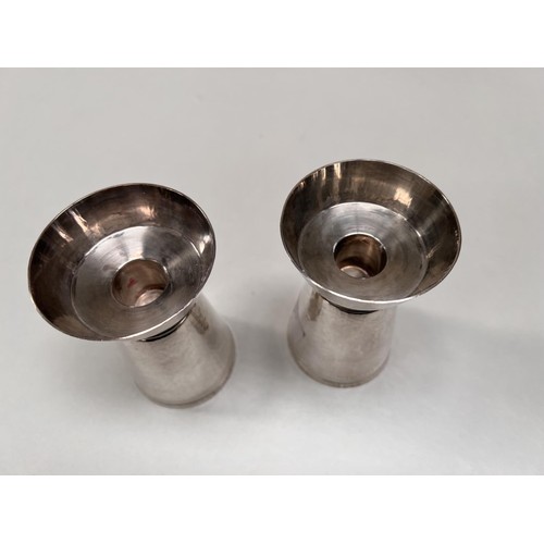 700 - A pair of silver modernist designer cylindrical planish candlesticks with flared rims and bases, ht.... 