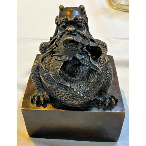 465 - A large Chinese bronze seal with dragon sat on top and seal mark to base, ht 16cm