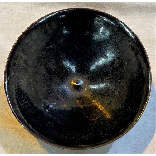 468A - A Chinese dark glazed bowl with small foot, leaf decoration in the glaze, 15cm dia