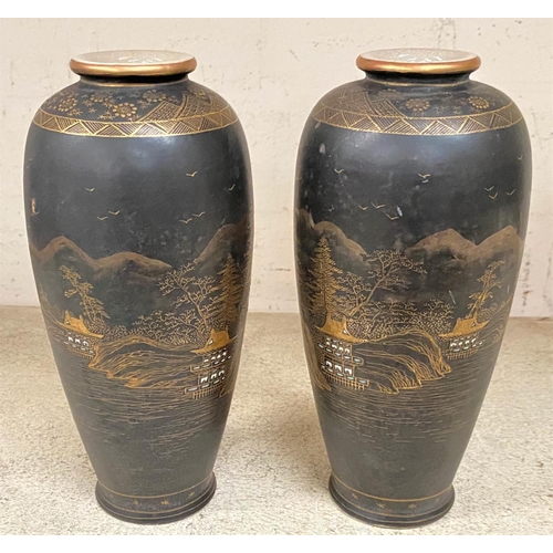 472 - An early 20th century pair of satsuma baluster vases, decorated with gilt landscapes against a black... 