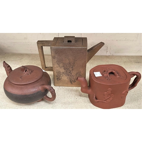 473 - Three Chinese stoneware teapots, terracotta coloured