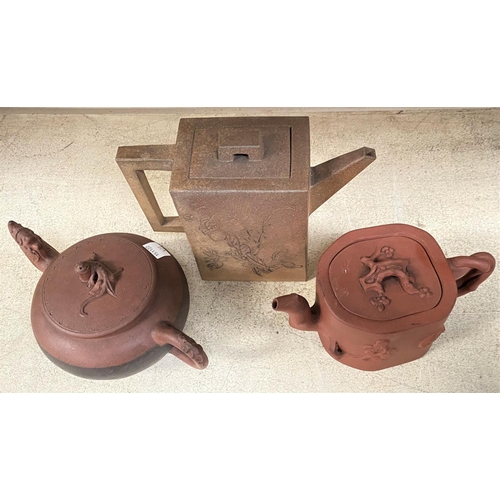 473 - Three Chinese stoneware teapots, terracotta coloured