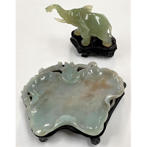 477 - A Chinese jade elephant on hardwood stand, length 10cm; a jade leaf shaped bowl on hardwood stand, l... 