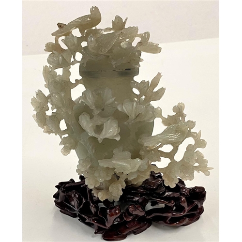 479 - A Chinese jade covered vase with extensive decoration of flowering branches and birds, on hardood st... 