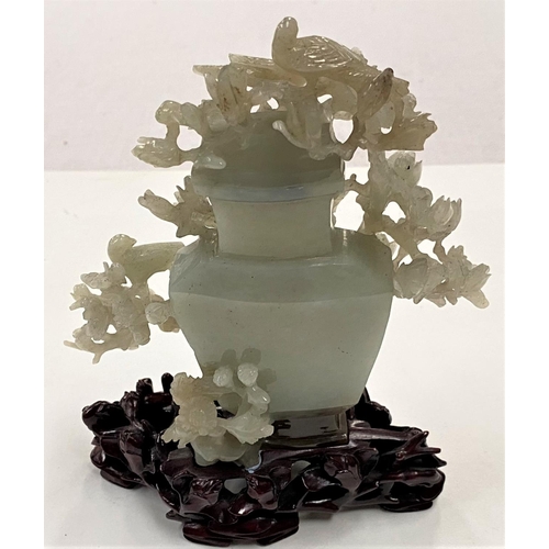 479 - A Chinese jade covered vase with extensive decoration of flowering branches and birds, on hardood st... 