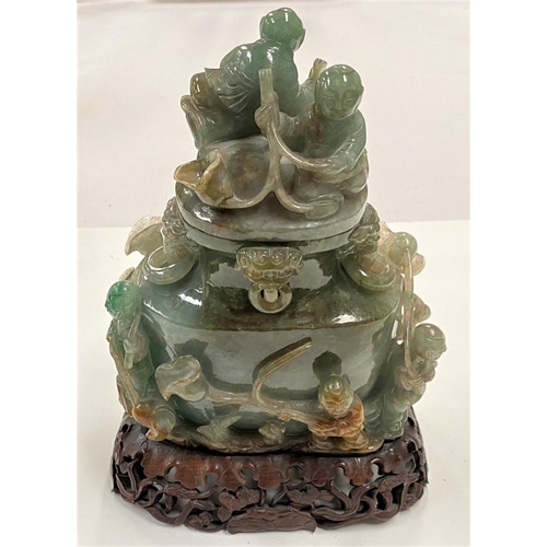 482 - A Chinese jade large covered vase with all-over decoration of figures, etc., on hardwood base, heigh... 