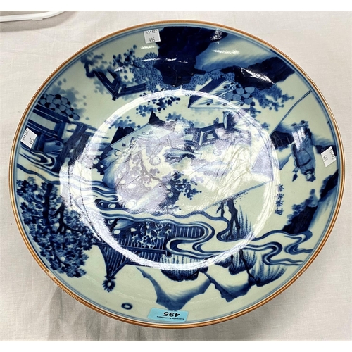 495 - A large Chinese blue & white charger with decoration of domestic mountain scene, characters to t... 