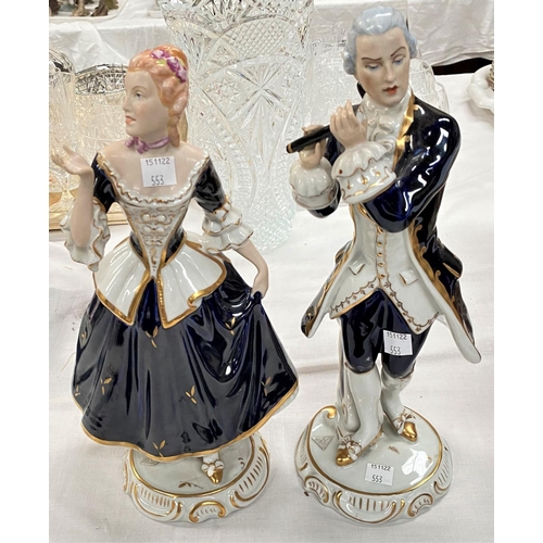 553 - A pair of Royal Dux figures: lady and gentleman in 18th century dress