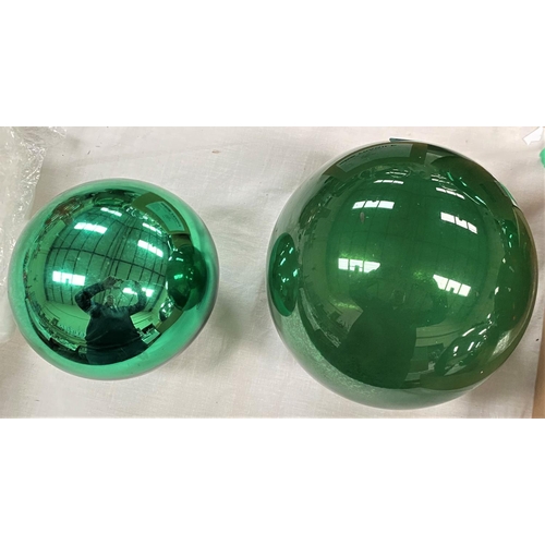 603 - A vintage green glass silvered witch ball, 14cm; a large clear glass ball, 17cm