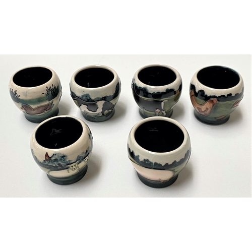 624 - A cased set of 6 Moorcroft egg cups depicting farm animals and birds, printed mark etc