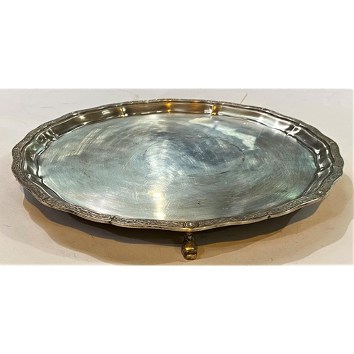 670 - A hallmarked silver circular salver with Celtic wavy border, on 4 dolphin feet, London 1961, 27oz