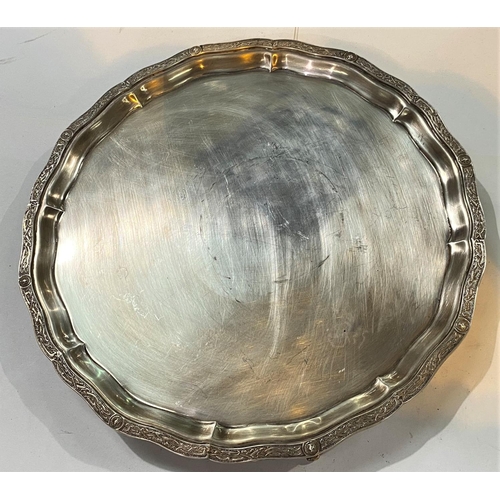 670 - A hallmarked silver circular salver with Celtic wavy border, on 4 dolphin feet, London 1961, 27oz