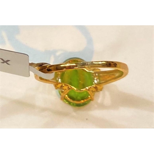 687 - A 9 carat hallmarked gold dress ring set large red dragon peridot, 3.97 carat, and 5 white zircons t... 