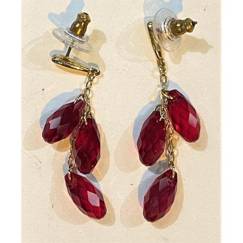 711 - Three pairs of Swarovski earrings:  1 single clear crystal; 1 triple red crystal drops; 1 ... 